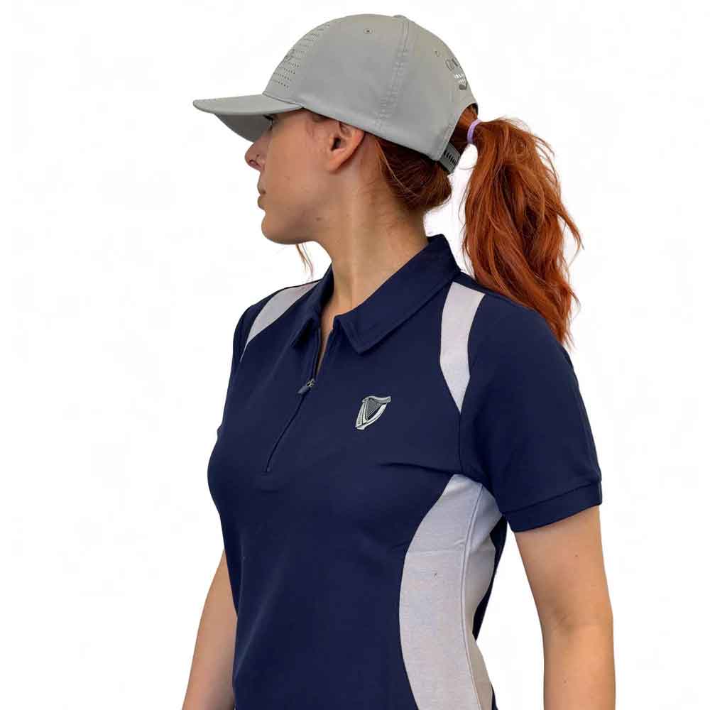 side on view of a woman wearing a guinness® white performance signature baseball cap in front of a white background