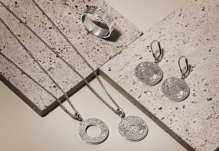 Silver History of Ireland rings, necklaces and earrings on a textured surface