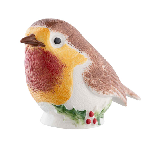 Decorative ceramic robin bird with a holly berry on a white background
