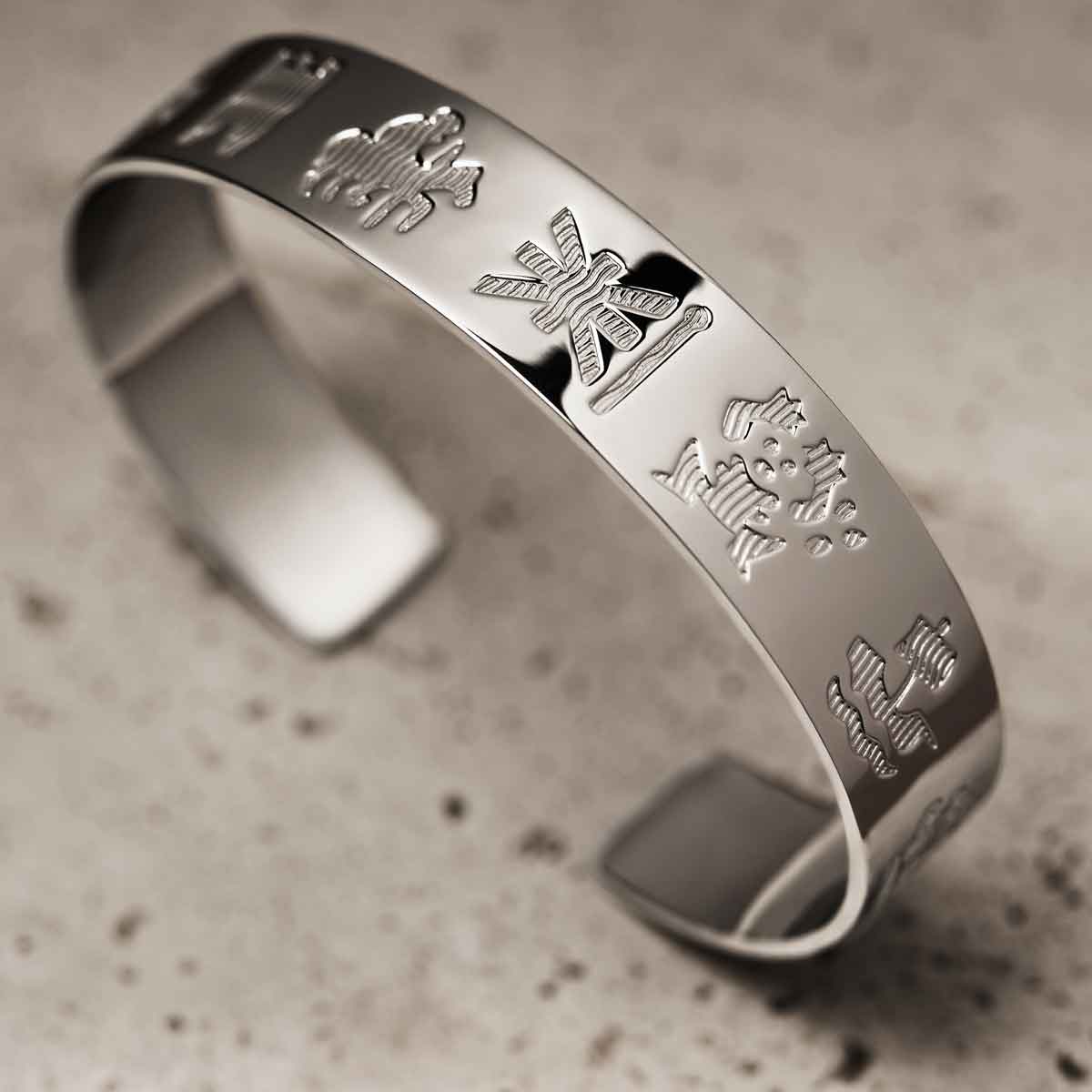 sterling silver history of ireland bangle on a textured surface
