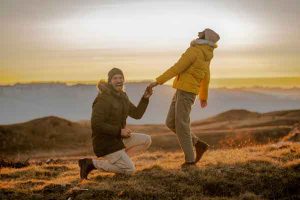 Man proposing to girl on mountaintop