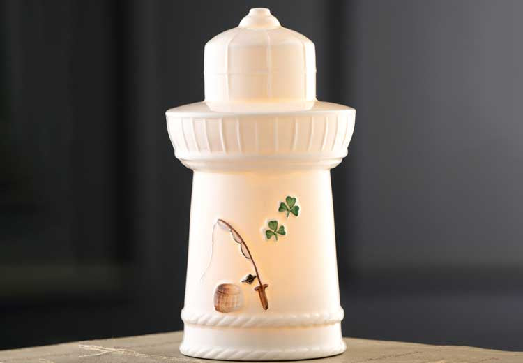 Belleek Pottery Edition Piece 2026 LED Irish Lighthouse with a shamrock and fishing rod detail on a dark background