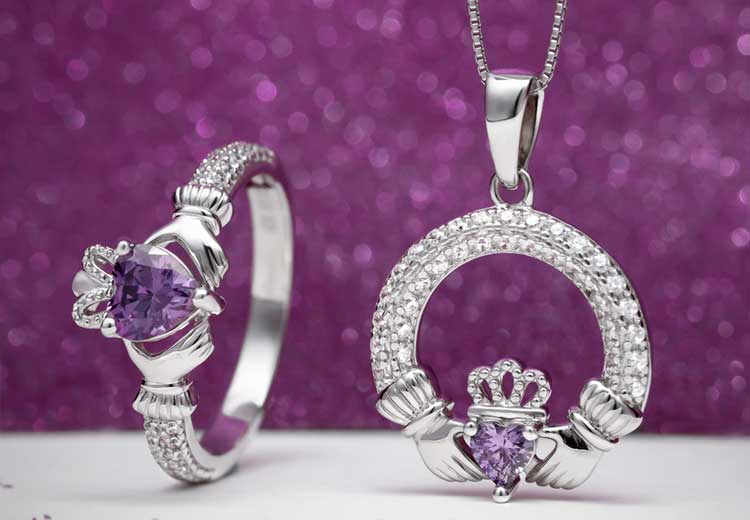 Sterling Silver Claddagh Ring & Necklace with February's Birthstone Amethyst against a sparkly purple backdrop