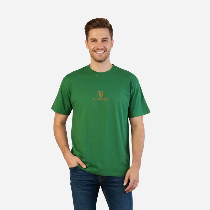 Man wearing a green Guinness® Are you Toucan to Me Green t-shirt with a logo on a white background