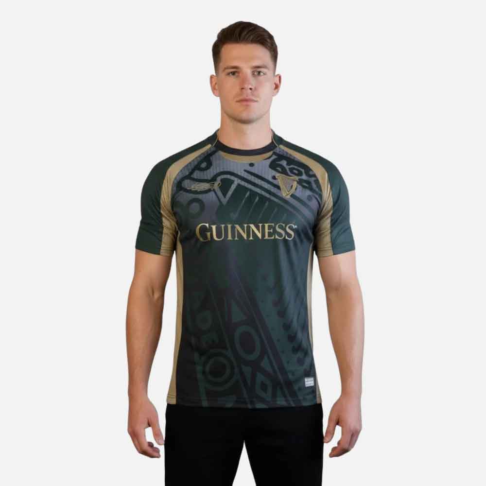 man wearing a guinness® retro harp performance soccer jersey on a white background