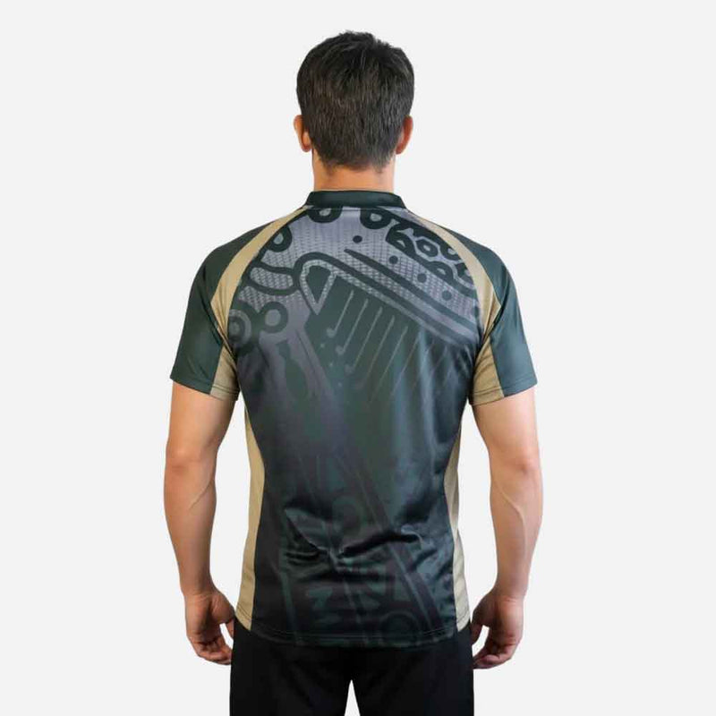 Person wearing a black & gold Guinness® Retro Harp Performance Soccer Jersey with a harp logo pattern on the back.
