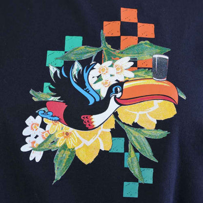 Closeup detail of the Colorful design seen on the Guinness® Hawaiian Ruched Ladies Black T-shirt
