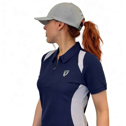 Side on view of a woman wearing a Guinness® White Performance Signature Baseball Cap in front of a white background