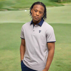 Person wearing a Guinness® Gray Performance Polo Shirt on a golf course