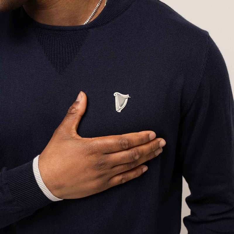 Guinness® Navy Performance Cotton Sweater with an embroidered harp logodesign on a plain background