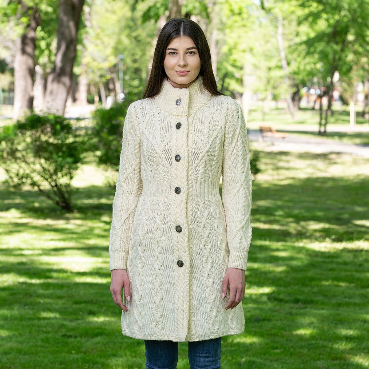 model wearing the merino wool aran cable knit signature ladies jacket in color natural