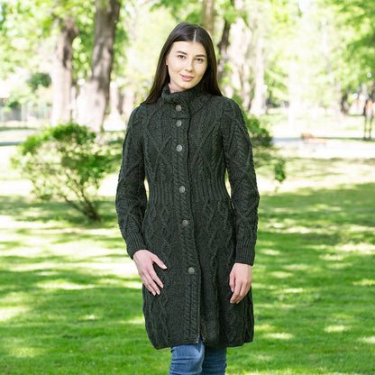 Model wearing the Merino Wool Aran Cable Knit Signature Ladies Jacket in color Army Green