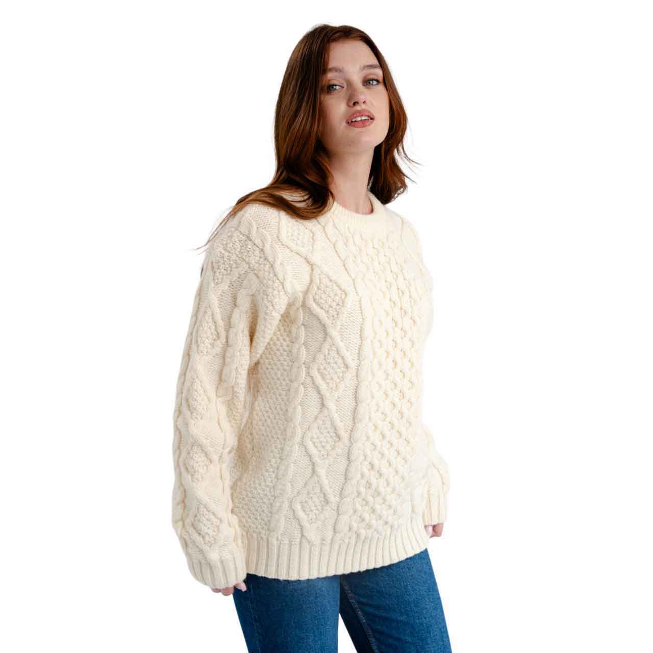 woman wearing a natural, white colored fisherman cable knit ladies sweater  on a white background