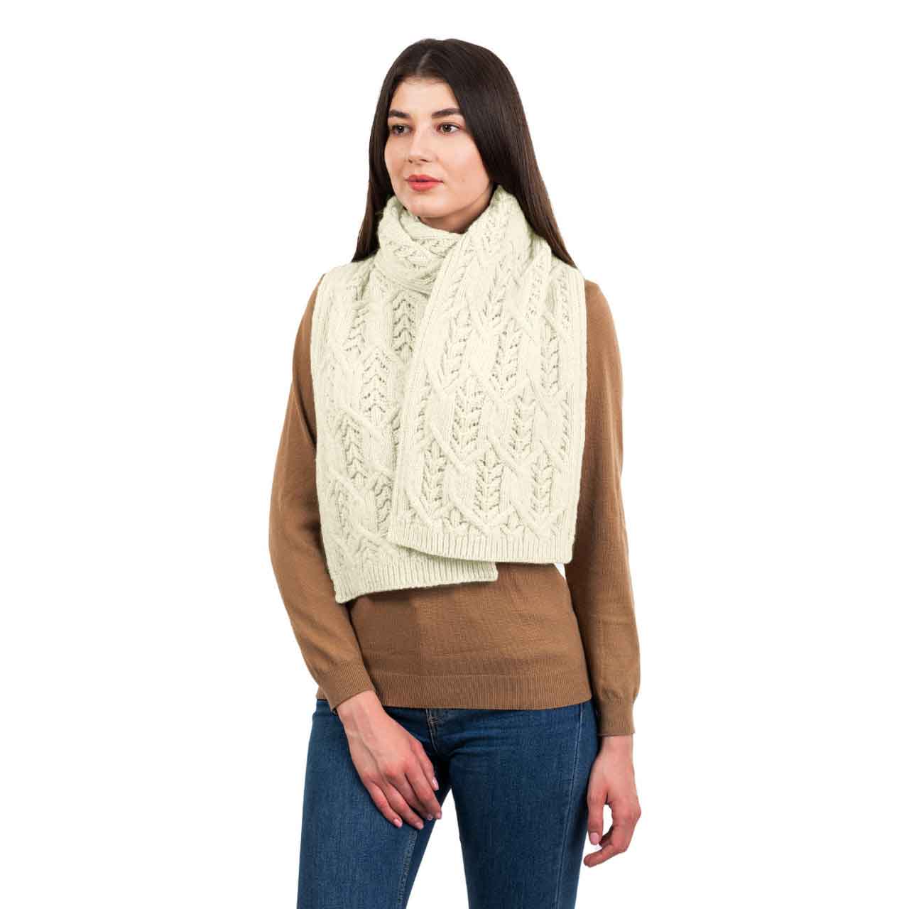 woman wearing a natural colored merino aran knit leaf ladies scarf
scarf on a white background