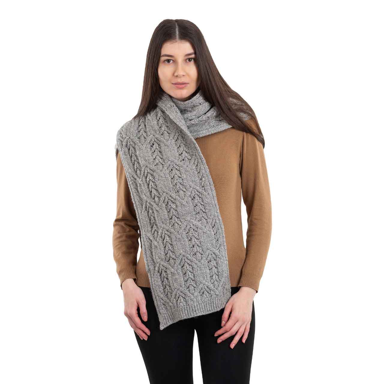 woman wearing a grey merino aran knit leaf ladies scarf
scarf on a white background