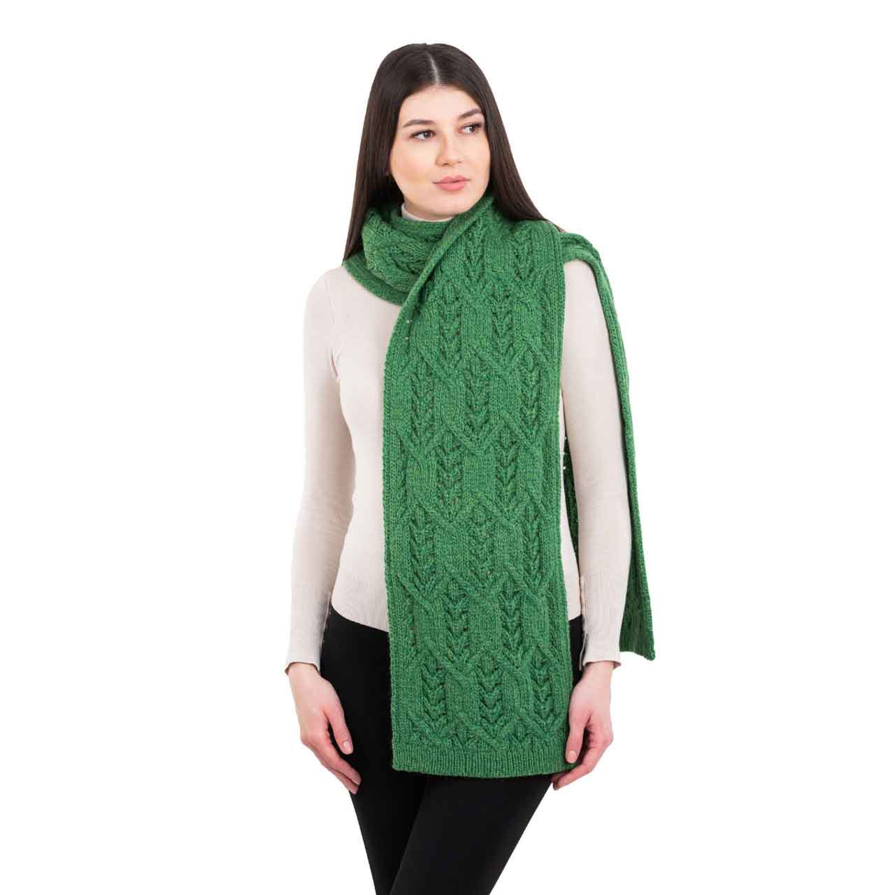woman wearing a green merino aran knit leaf ladies scarf
scarf on a white background