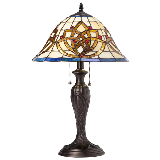 A Celtic Blooming Flower Stained Glass Tiffany-style table lamp with a stained glass shade featuring a Celtic knot design in cream, blue, gold, and red, mounted on a dark bronze metal base with pull-chain switches.