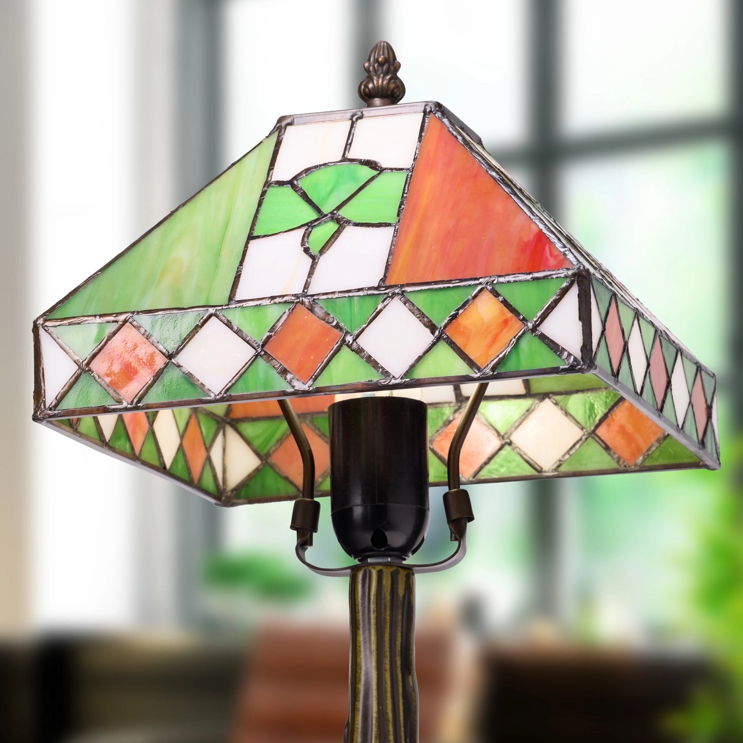 a tiffany-style st. patrick's day irish flag tricolor stained glass table lamp in green, orange, white, and pink, set against a softly blurred indoor background.