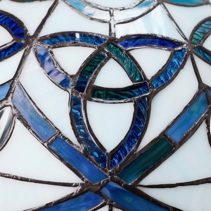 Close-up of Celtic Stained Glass Dome Trinity Knot Table Lamp
with blue and green colored glass panels.