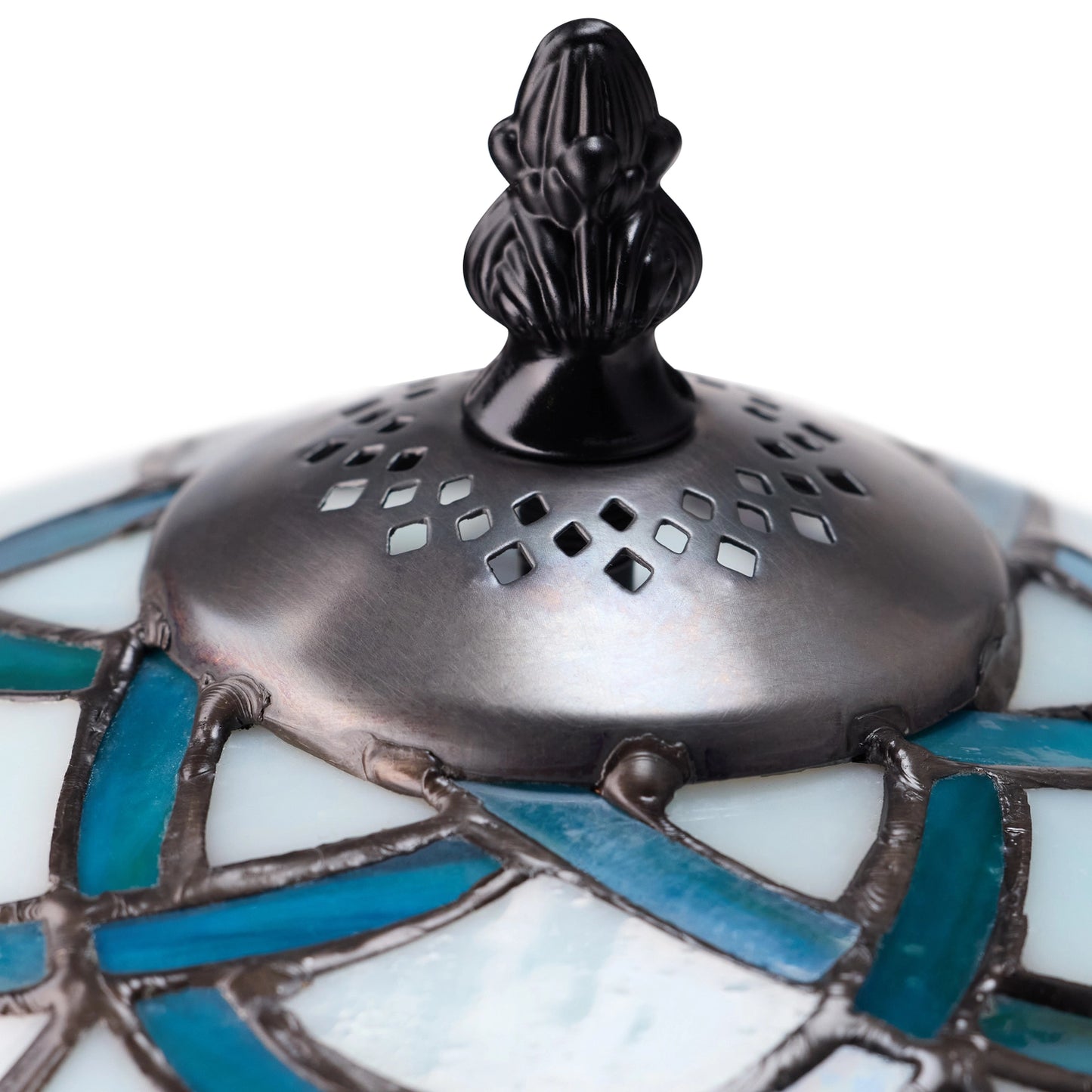 closeup of celtic stained glass dome trinity knot table lamp with ornate dark resin finial.