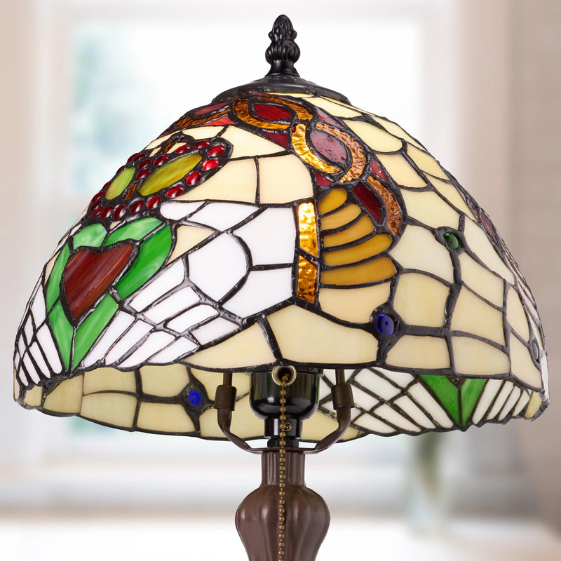 Claddagh Stained Glass Table Lamp  with a Tiffany-style dome shade featuring the Claddagh motif in cream, green, red, gold, and brown tones, with a dark metal finial and chain.