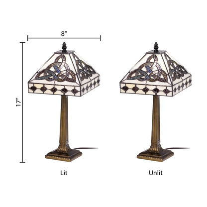Two views of Celtic Trinity Knot Stained Glass Table Lamp on a white background, one labeled 'Lit' and one labeled 'Unlit', with dimension lines showing 8 inches wide and 17 inches tall. 