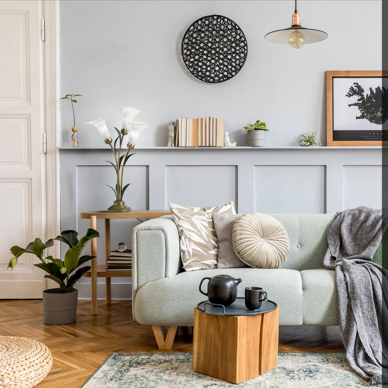 Handblown Glass 3 Light White Lily Table Lamp on a table beside a sofa in a modern interior