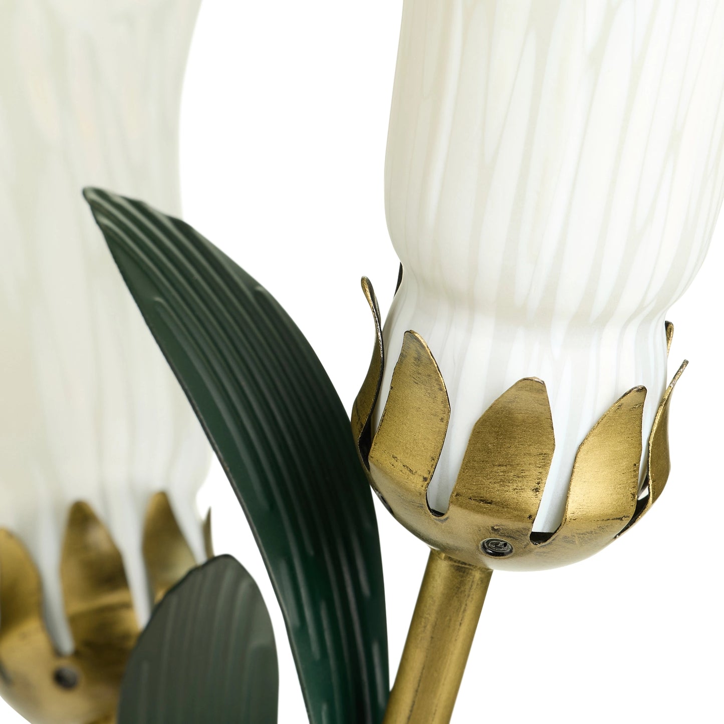 close-up of a decorative handblown glass 3 light white lily table lamp shades, with gold-toned holders, and dark green leaf accents on a white background.