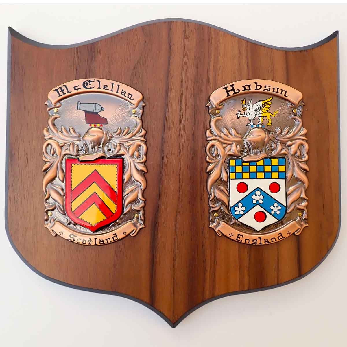 coat of arms | hand painted double plaque medium: two painted family crests mounted on a wooden shield base, on a white background