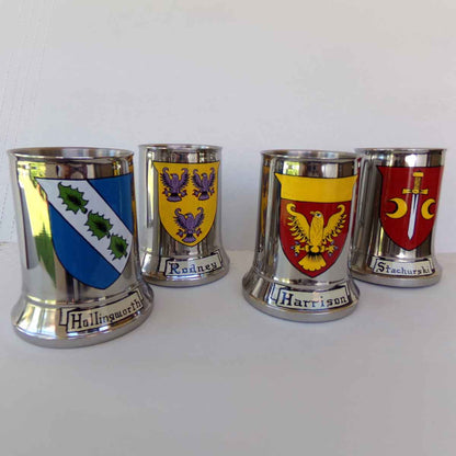 Four Stainless Steel Tankards hand painted with various Coats of Arms of names with different Irish and European origin