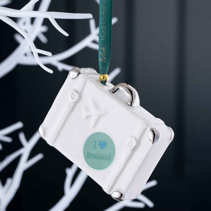 Belleek Vintage Suitcase Ornament -  Reverse view of A White decorative ornament with 'I ❤️ Ireland' text, hanging on a branch against a dark background.