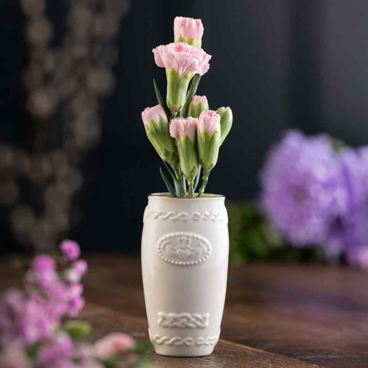 Belleek Pottery Claddagh Mini Irish Vase with pink flowers on a wooden surface