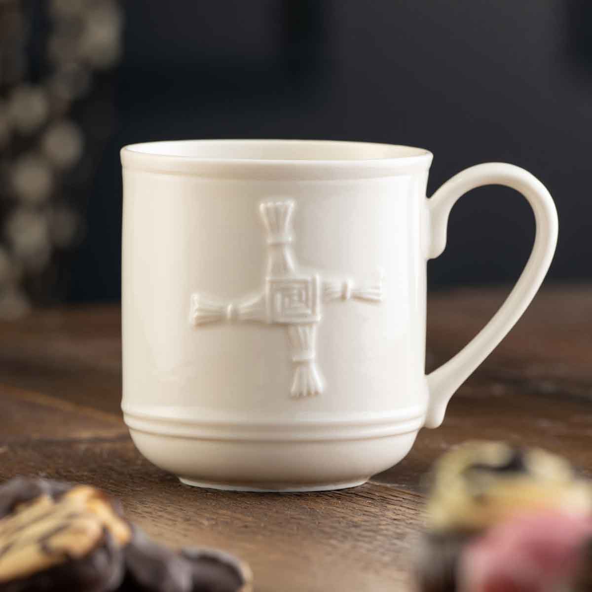 belleek pottery st.bridget's cross irish mug on a wooden surface