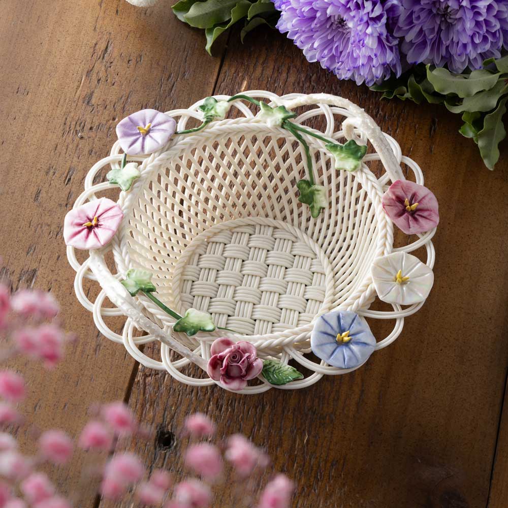 belleek pottery morning glory irish basket on a wooden surface