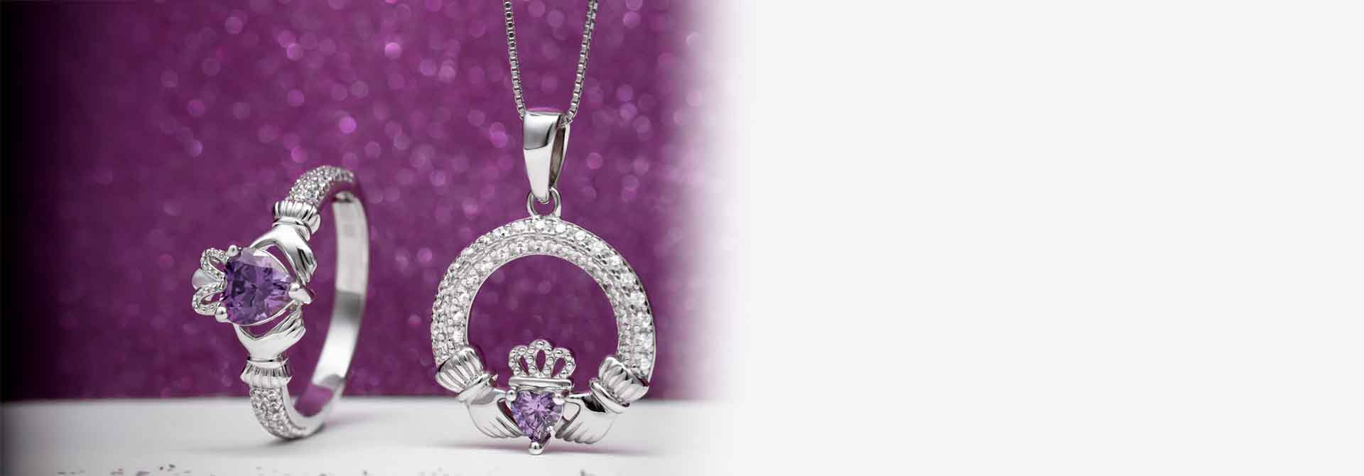 Sterling Silver Claddagh Ring & Necklace with February's Birthstone Amethyst against a purple backdrop