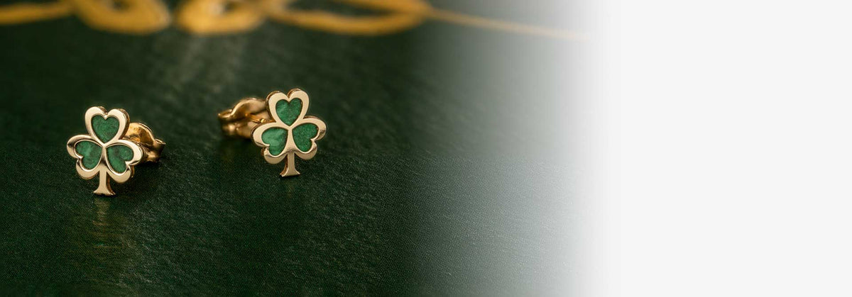 10k Gold Malachite Shamrock Stud Earrings on a dark green surface