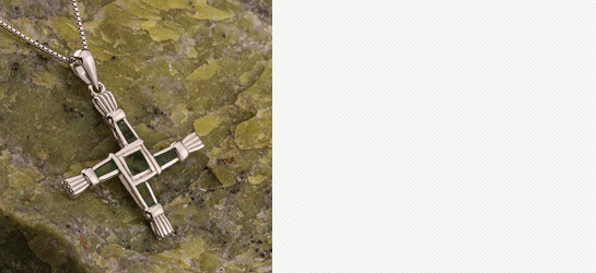 Sterling Silver Connemara Marble Saint Bridget's Cross necklace on a piece of green Connemara marble