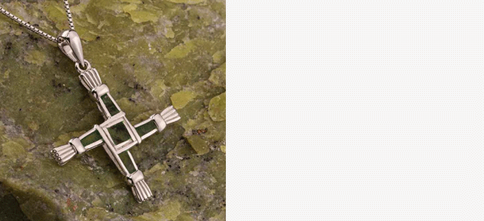 Sterling Silver Connemara Marble Saint Bridget's Cross necklace on a piece of green Connemara marble