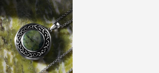 A round Connemara Marble Celtic Necklace in Sterling Silver, on a green marble background
