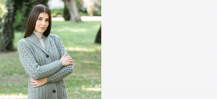 Woman with dark hair wearing an Aran Knit Irish Womans Cardigan standing in a park