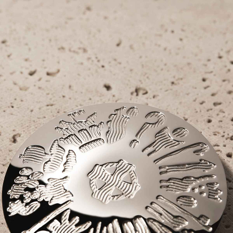 Sterling Silver History of Ireland Brooch lying flat on a textured beige surface