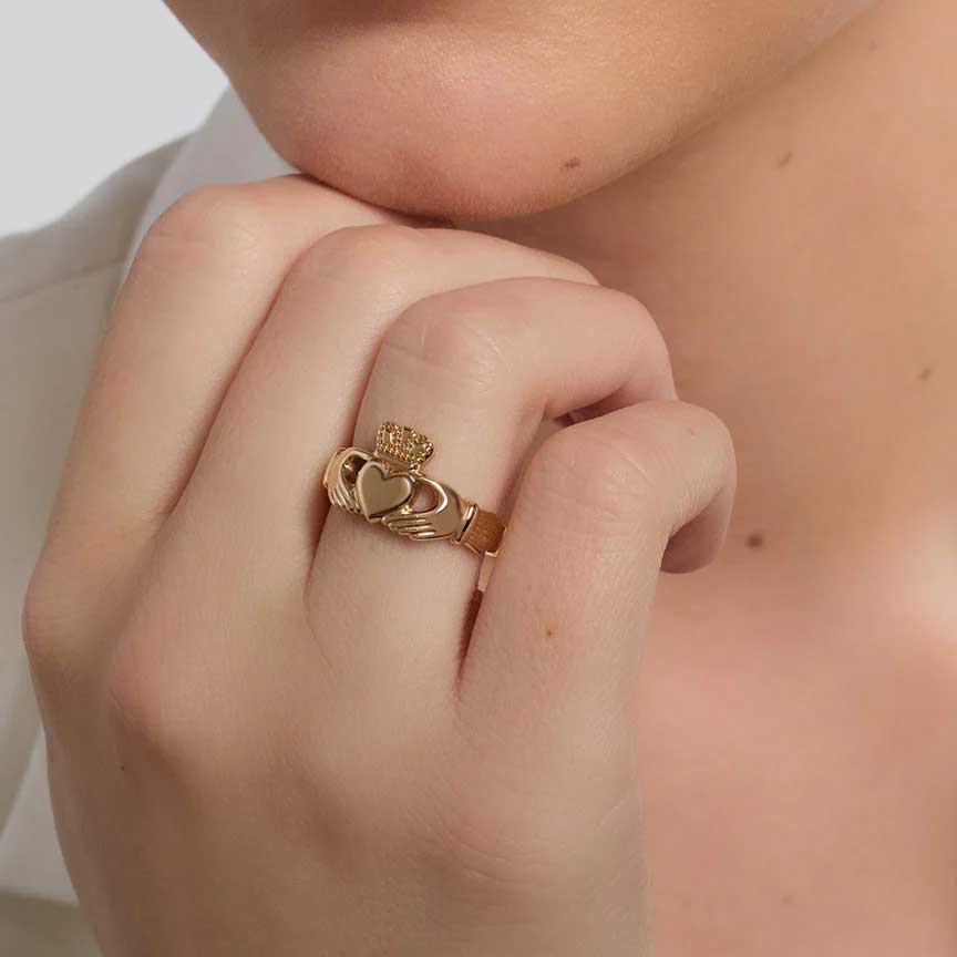 women's 14k gold puffed heart claddagh ring on a female model's finger