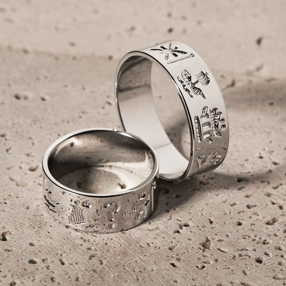 sterling silver history of ireland rings on a textured beige surface