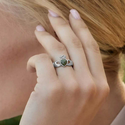 Blonde Woman displaying a Sterling Silver Claddagh Ring with Connemara Marble Heart on her left hand