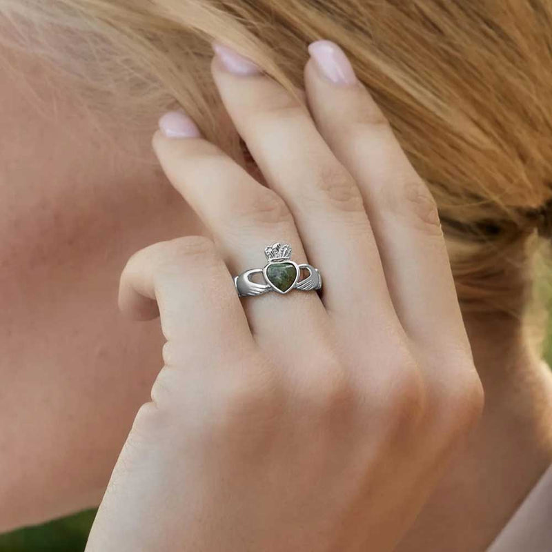 Blonde Woman displaying a Sterling Silver Claddagh Ring with Connemara Marble Heart on her left hand