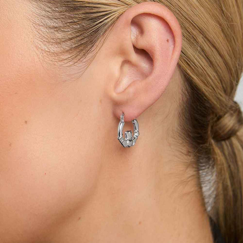 Sterling Silver Small Hoop Claddagh Earring worn by a woman with blonde hair tied back.