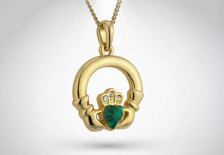 Gold-plate claddagh pendant with a green heart crystal on a grey background
