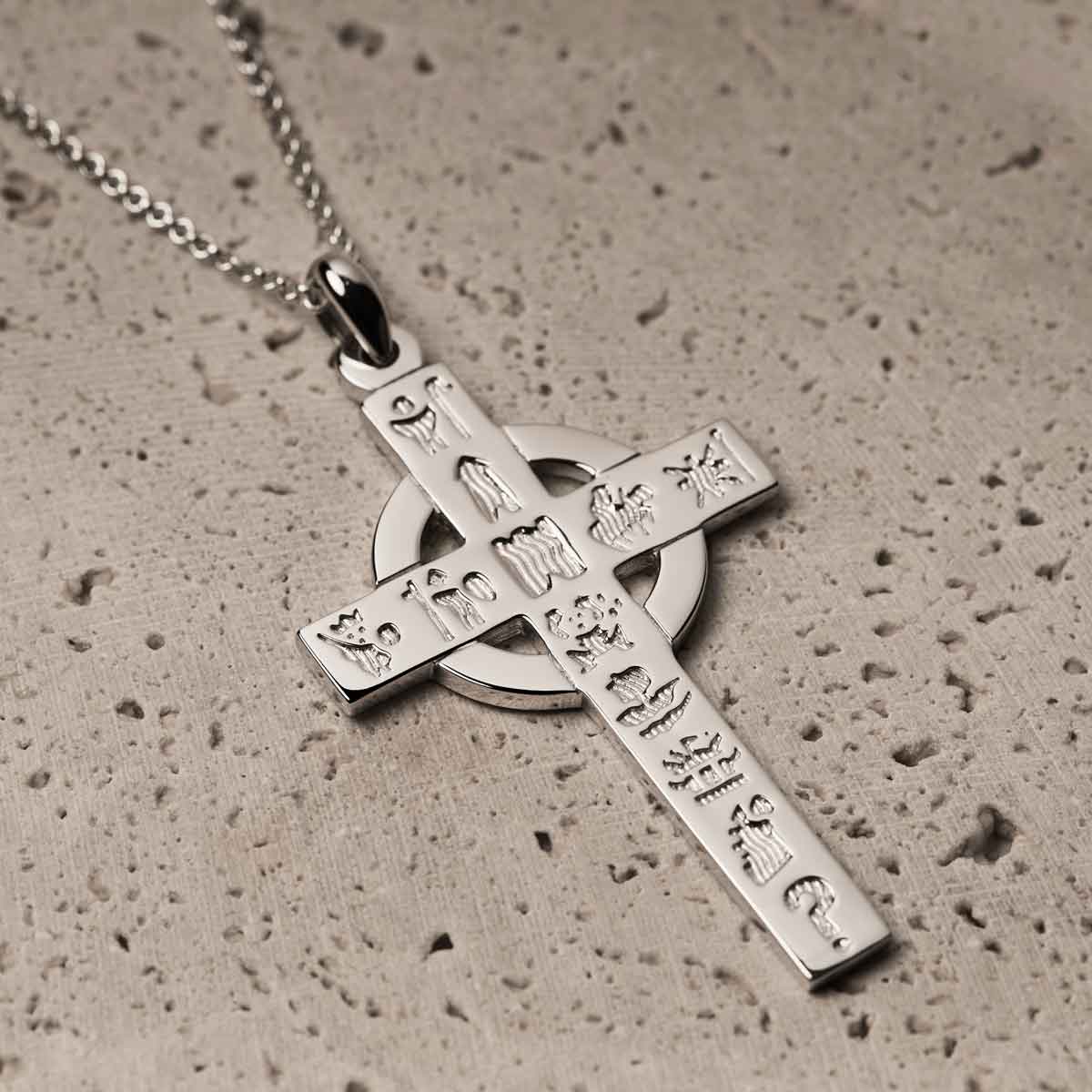 irish necklace | sterling silver history of ireland celtic cross pendant on a textured surface