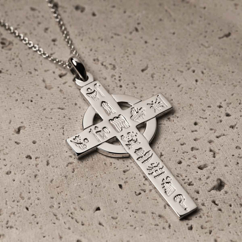 Irish Necklace | Sterling Silver History of Ireland Celtic Cross Pendant on a textured surface