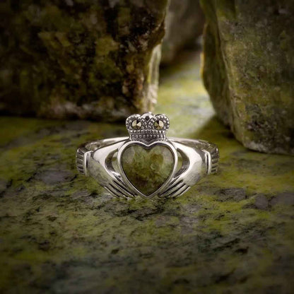 Ladies Sterling Silver Marcasite Irish Connemara Marble Claddagh Ring on a Connemara Marble surface
